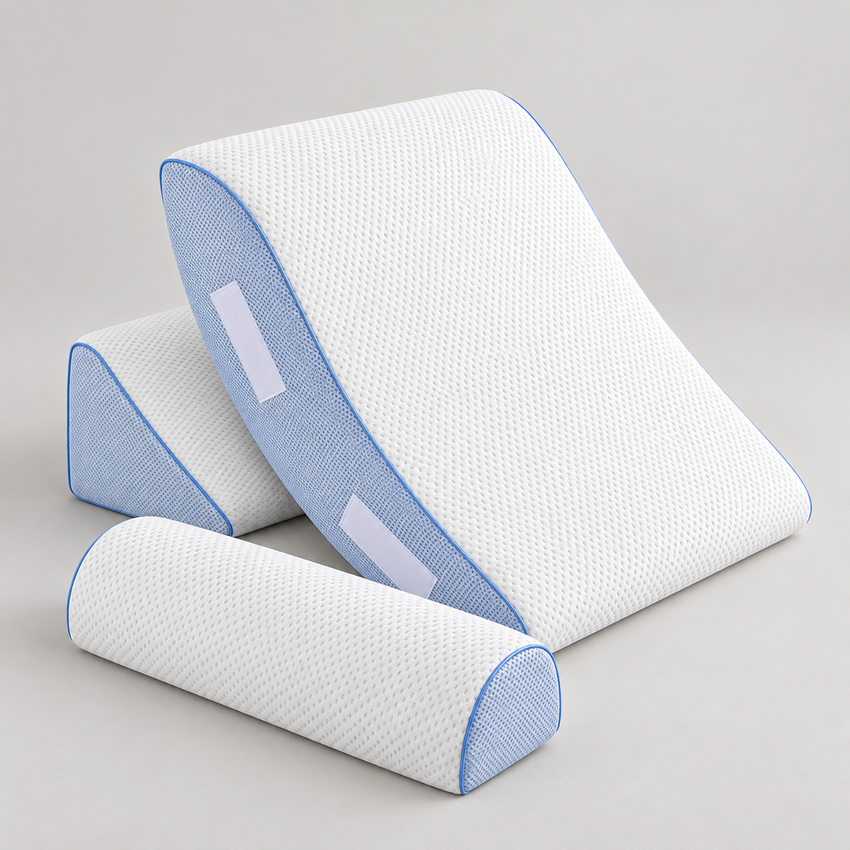 Cooling Wedge Pillow three-piece set with a white textured main wedge, blue mesh-like side panels and piping, a separate base piece and a rounded semi-cylinder component.