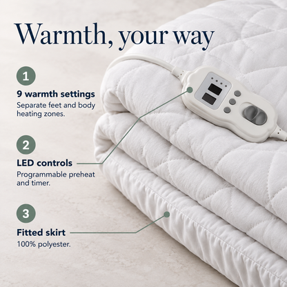 Electric blanket controller beside white quilting, with information about warmth settings, heating zones and programmable timing.