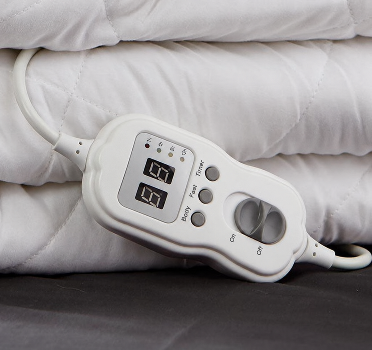 Close-up of electric blanket controls and quilted fabric
