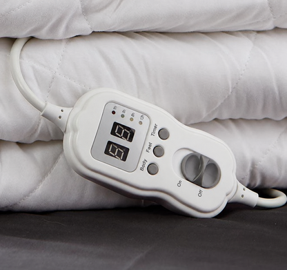Close-up of electric blanket controls and quilted fabric