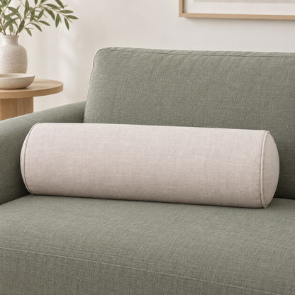 Natural linen bolster cushion styled on a eucalyptus-colour sofa
